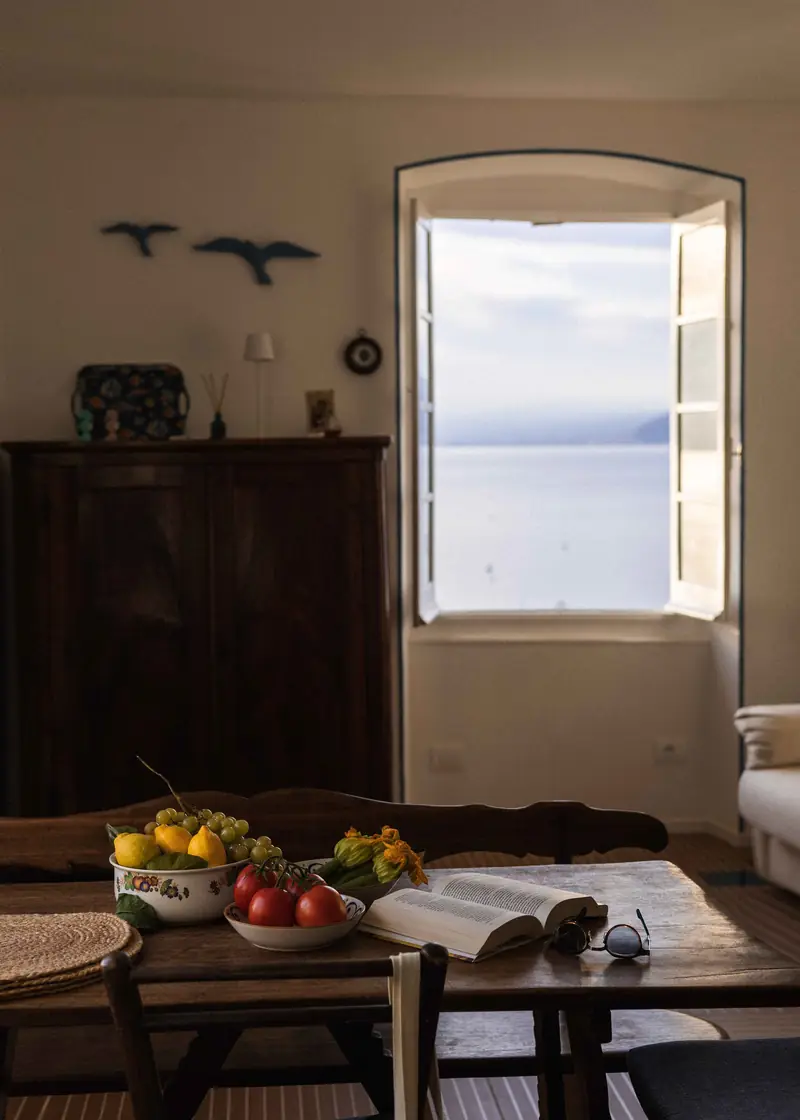 Antique sideboard and an open window on the sea
